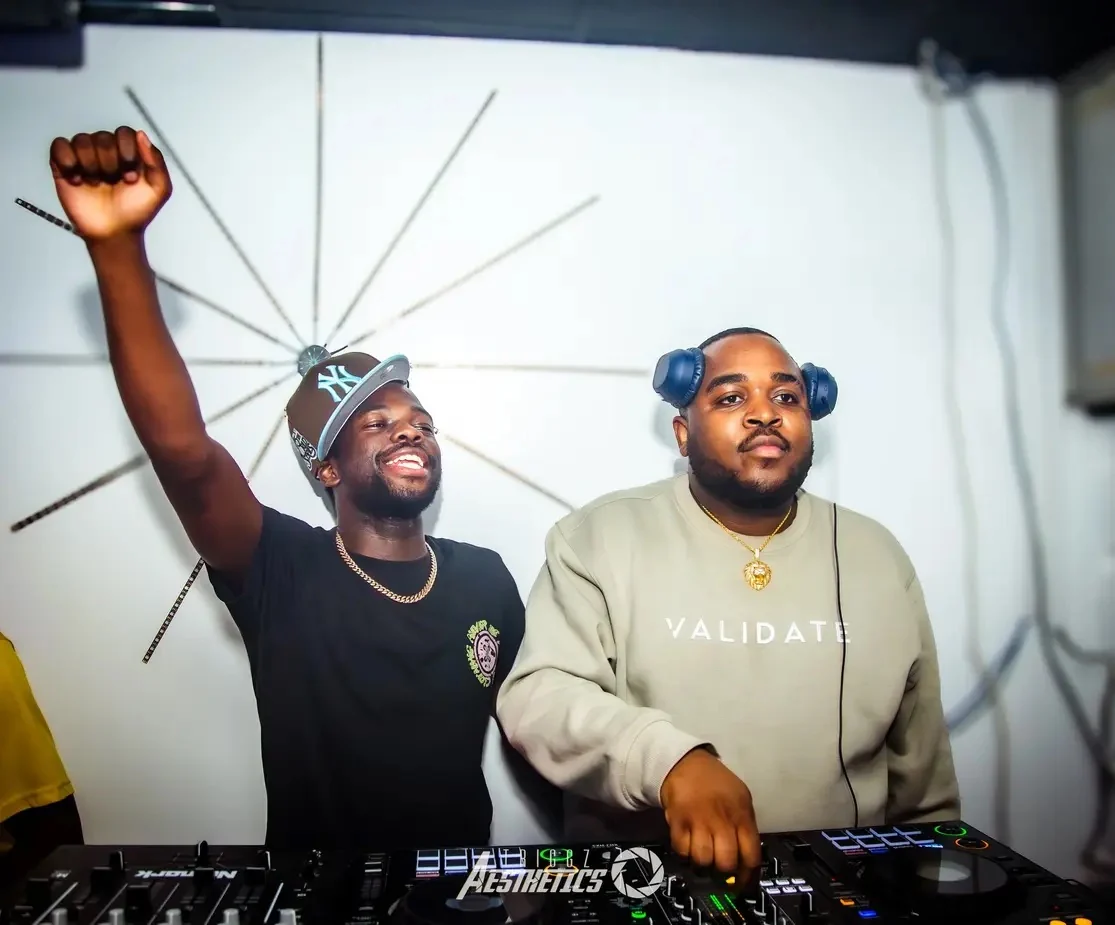 Mazphilela and his friend at the decks, one with his arm raised